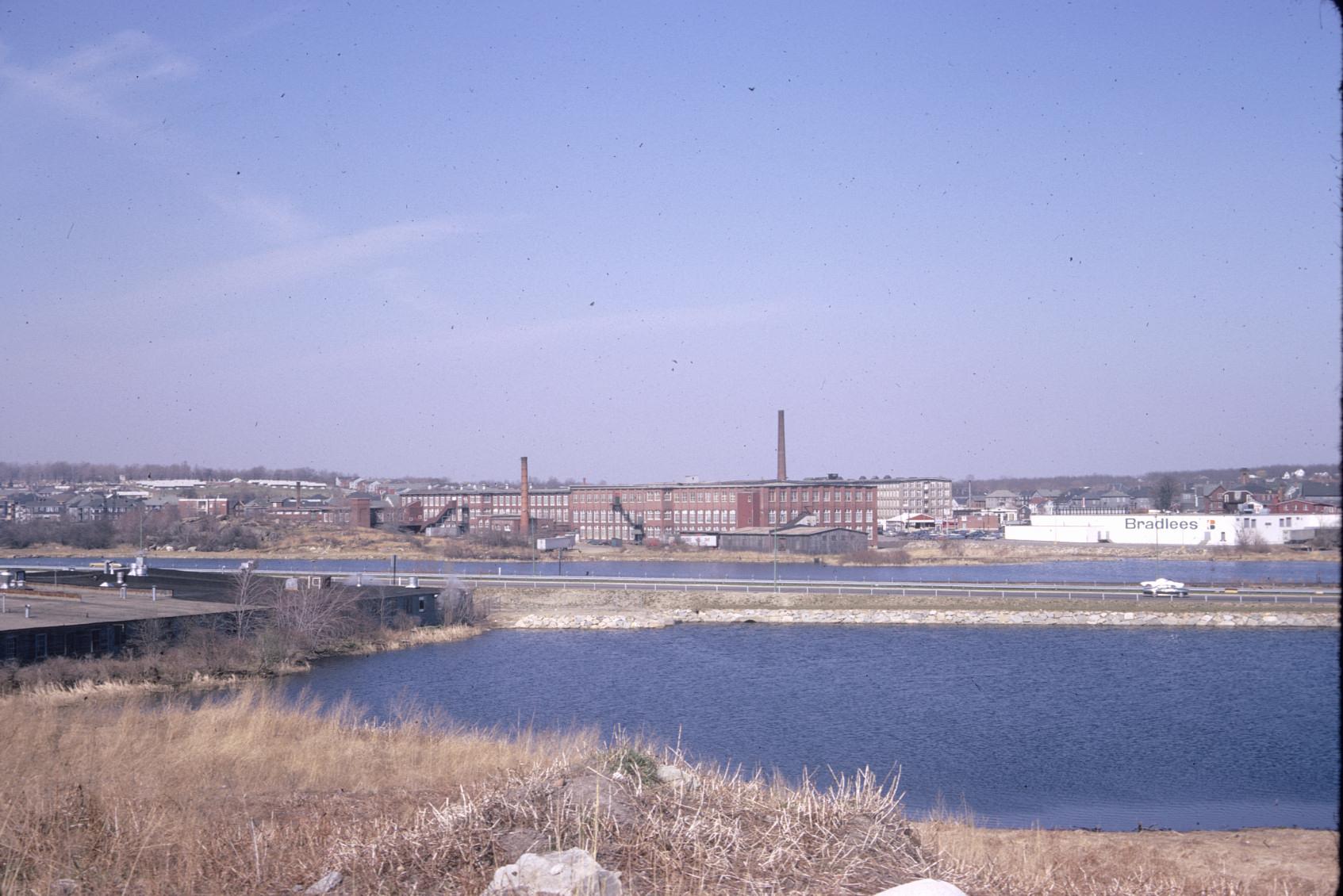 Distant view of the Pilgrim Mills on the Quequechan River in Fall River, MA.…