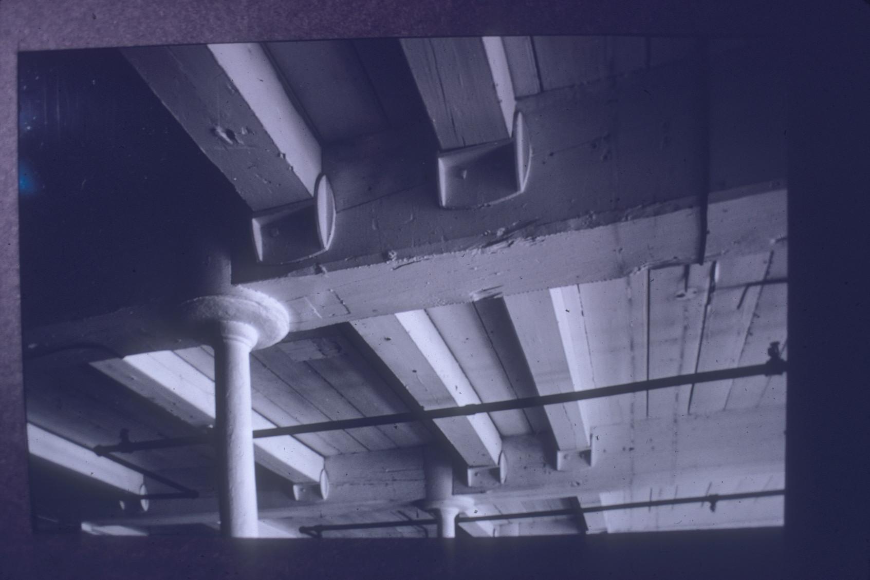 View of the cast iron beams and column in the basement of the Metacomet Mill in…