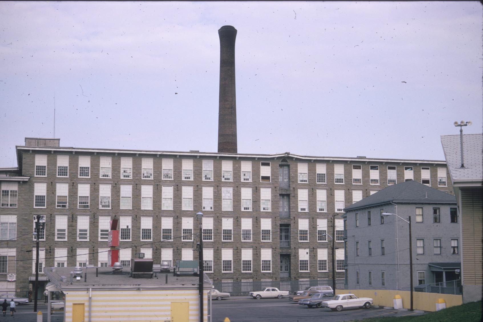 View of backside of Laurel Lake Mills.  Large stack visible.  