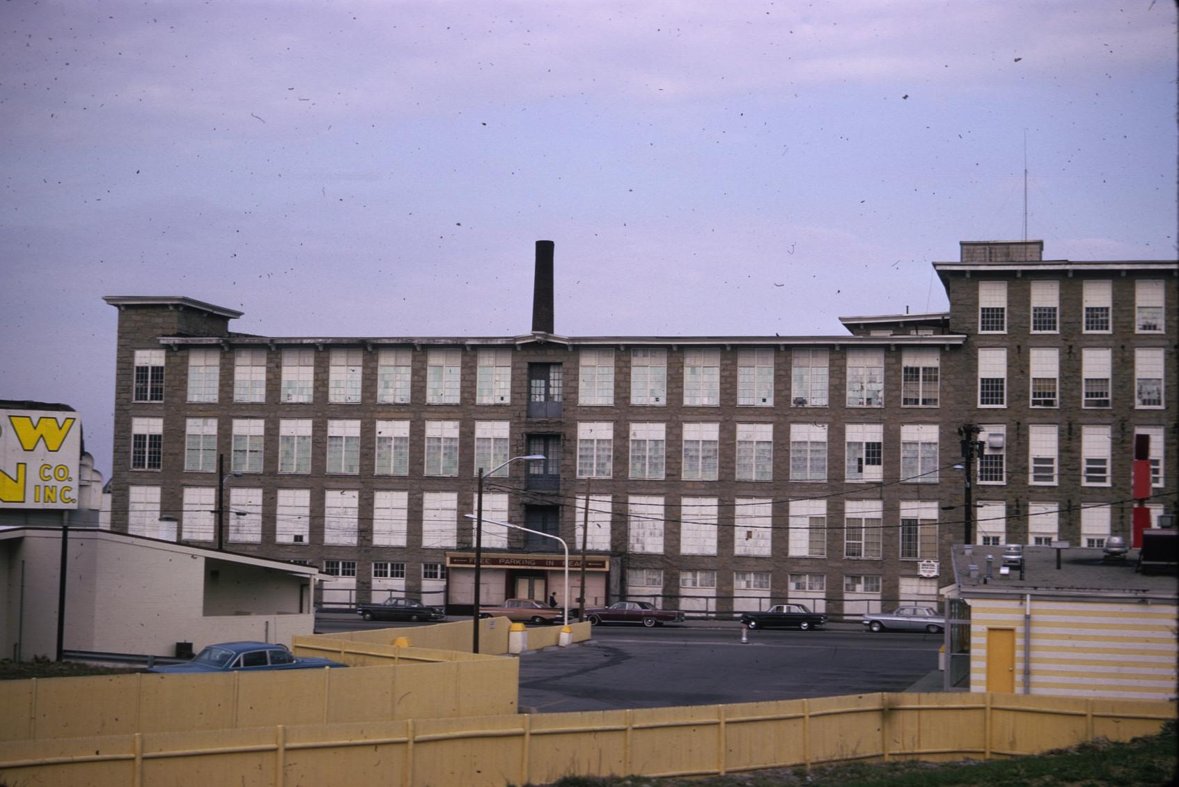 View of backside of Laurel Lake Mills.  Large stack visible.