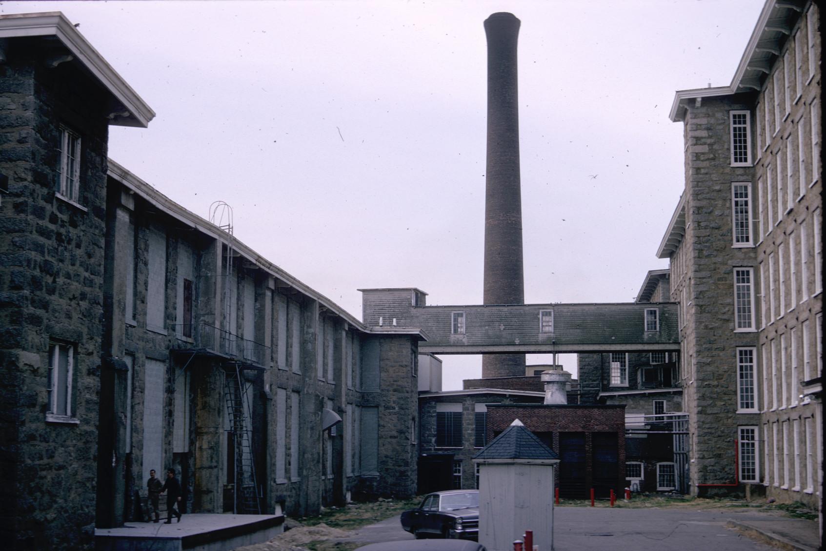 View of skyway and large stack at the King Philip Mills complex.  