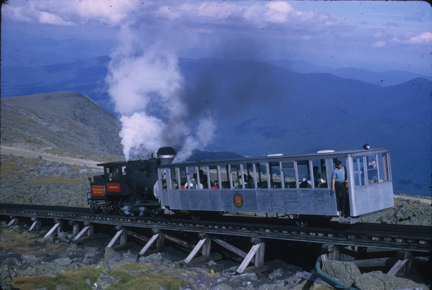 Train approaching summit of Mount Washington on elevated track