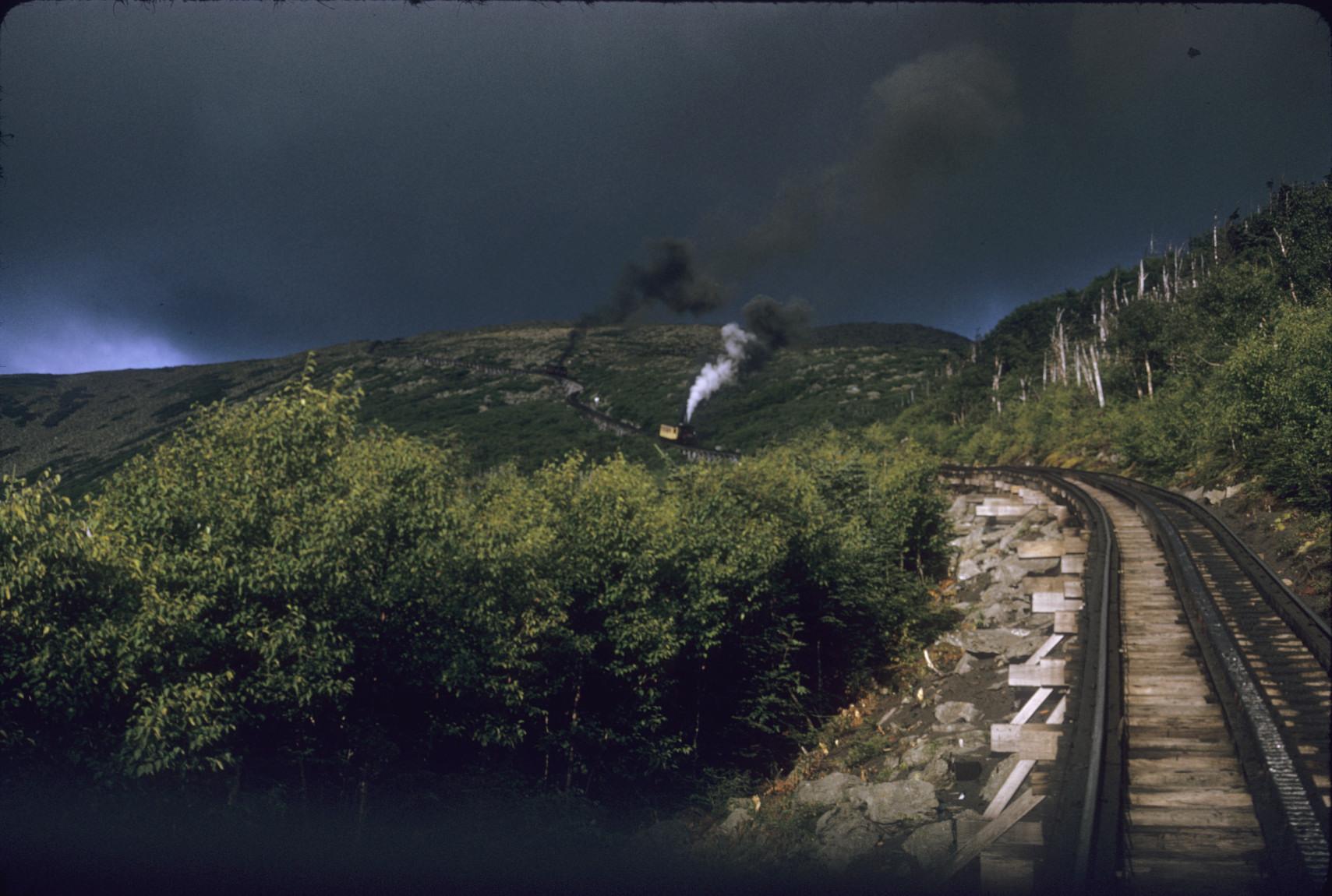 Distant view of two trains on curving incline