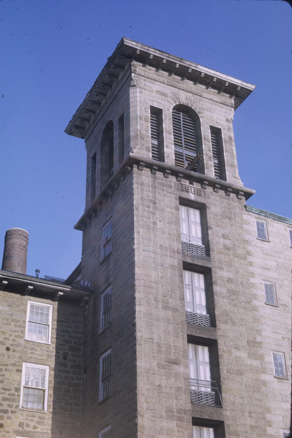 View of bell tower of Durfee Mill No. 1.  Stack also visible.