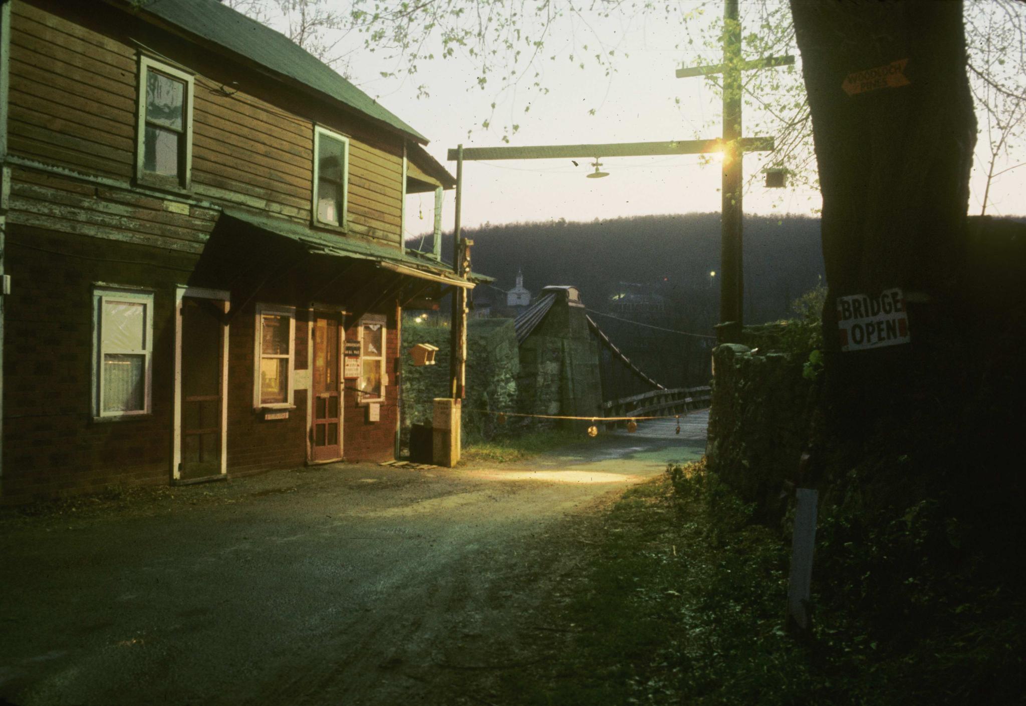 Photograph of toll house on New York side of the Delaware Aqueduct at dusk.…