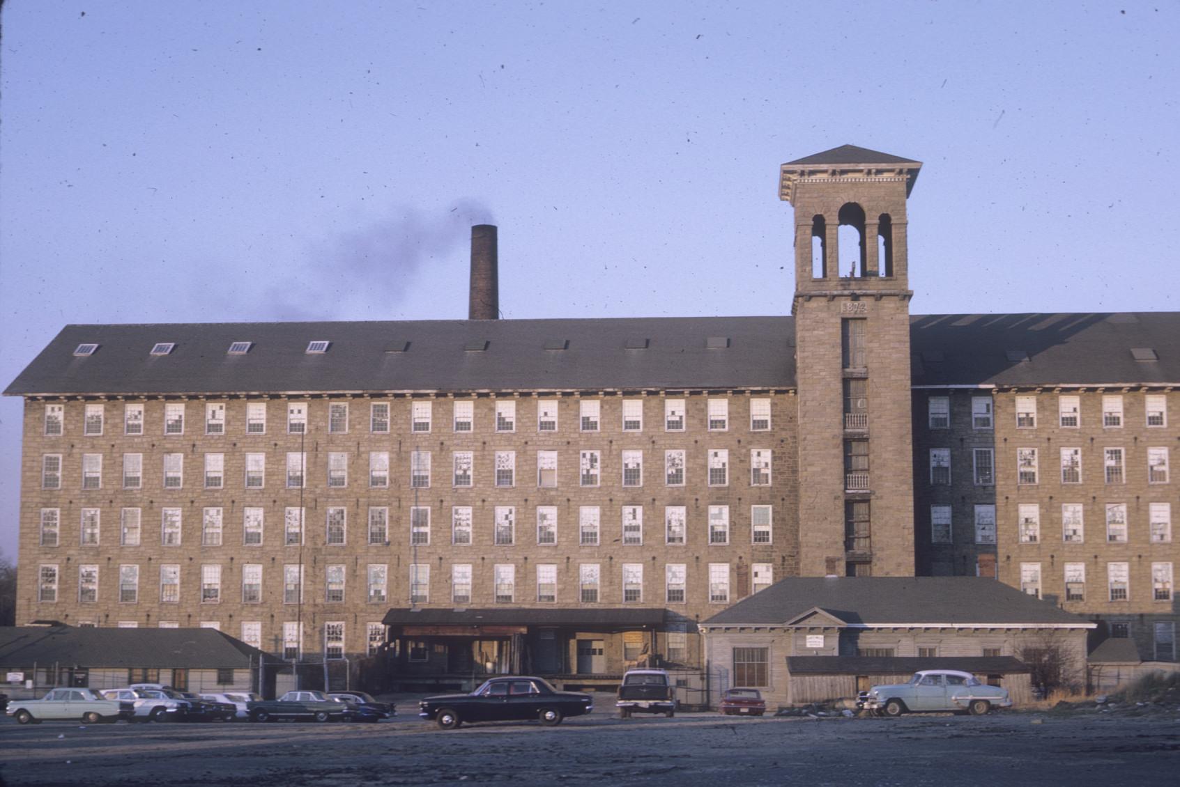 View of front of Chase Mill.  Stack visible in rear and bell tower.