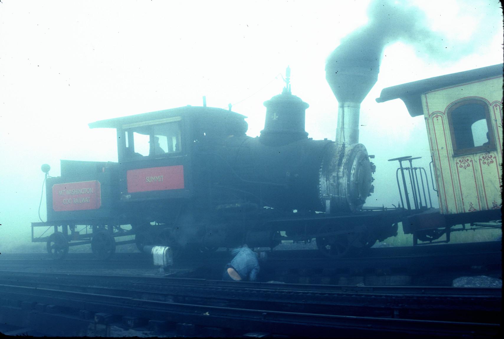 Steam engine \"Summit\" being inspected in fog