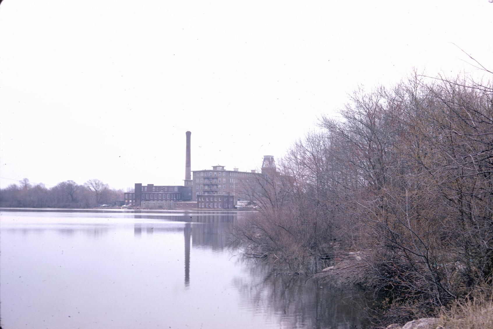 View of Bourne Mill overlooking Laurel Lake.  Stack visible. 