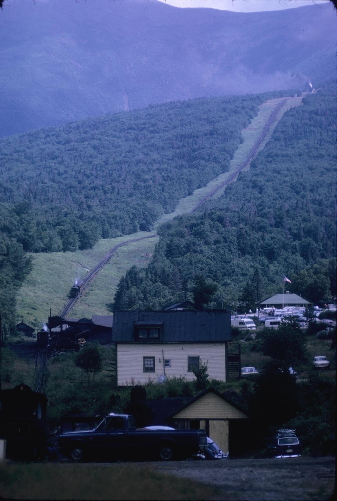 Long view of track up mountain slope taken from shops below Base station