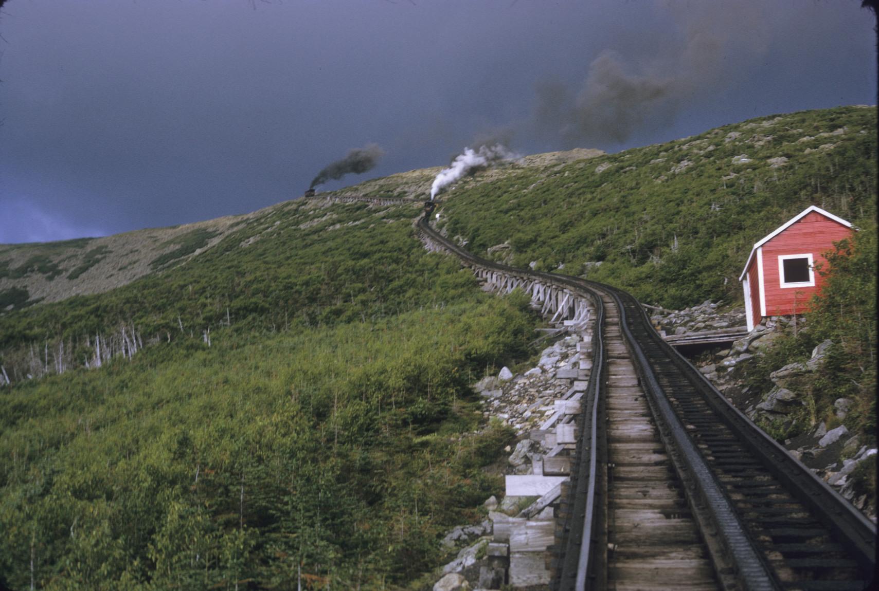 Track on upper slope with two trains, way station