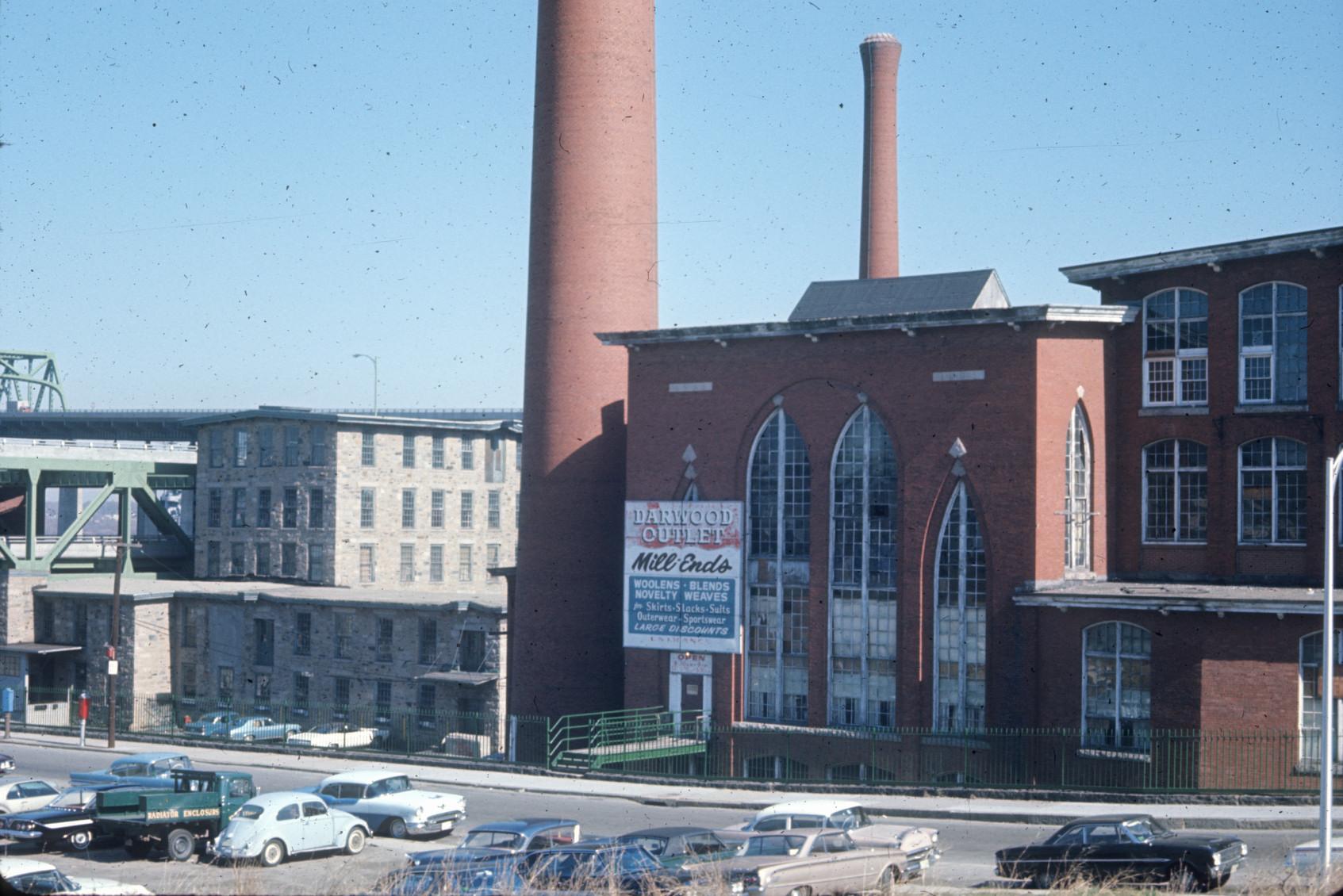 View of side entrance and two stacks at the American Print Co. Mill No. 7.