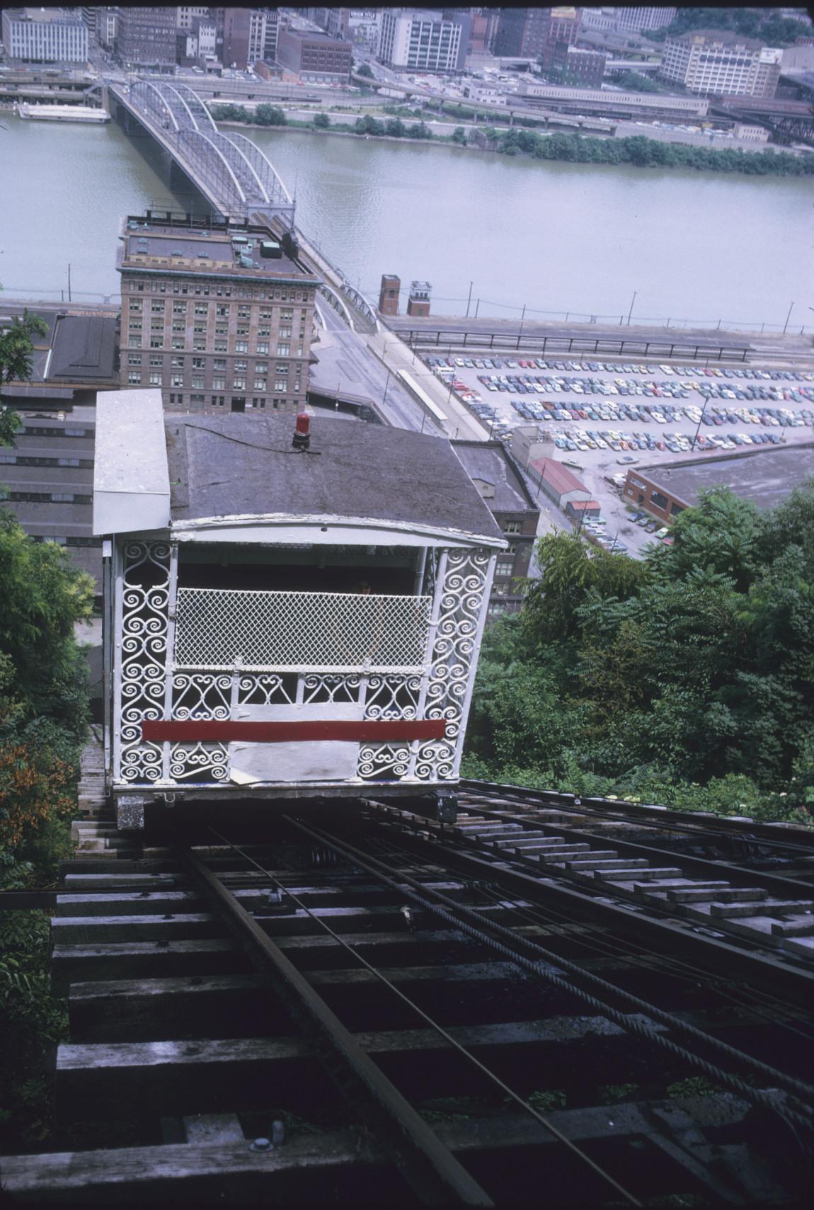 View down incline past car; includes Station Square and Smithfield Street bridge