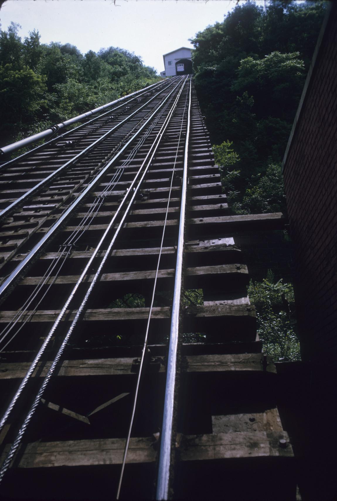 View of track with slope and top station in distance