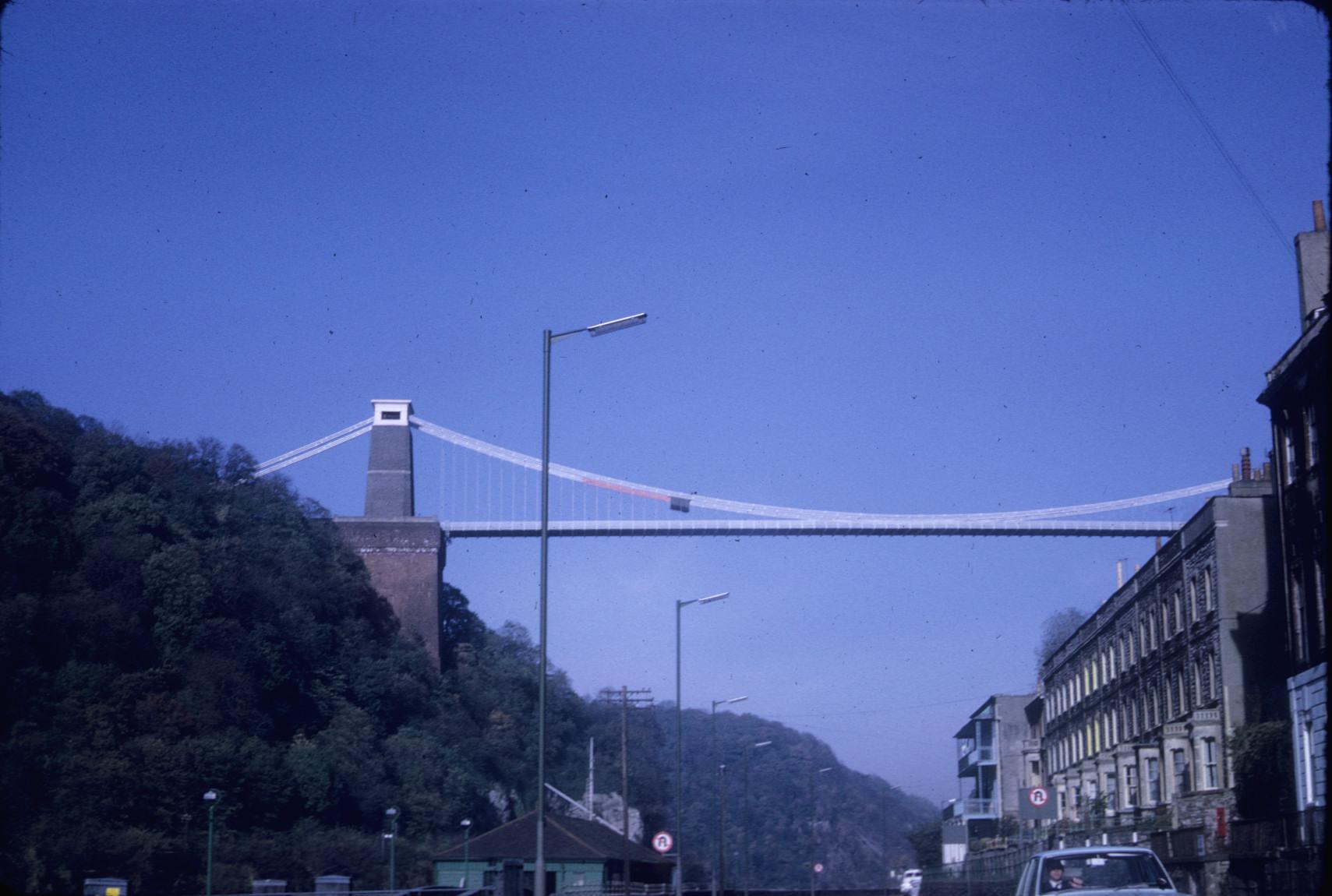 Shows bridge above city and ravine