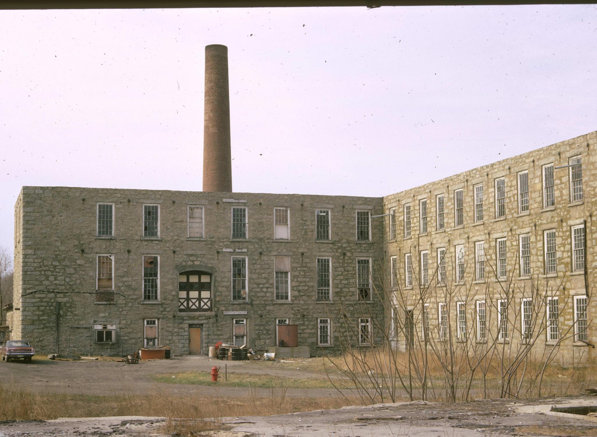 View of the rear of the Shove Mill in Fall River.  Large stack visible.