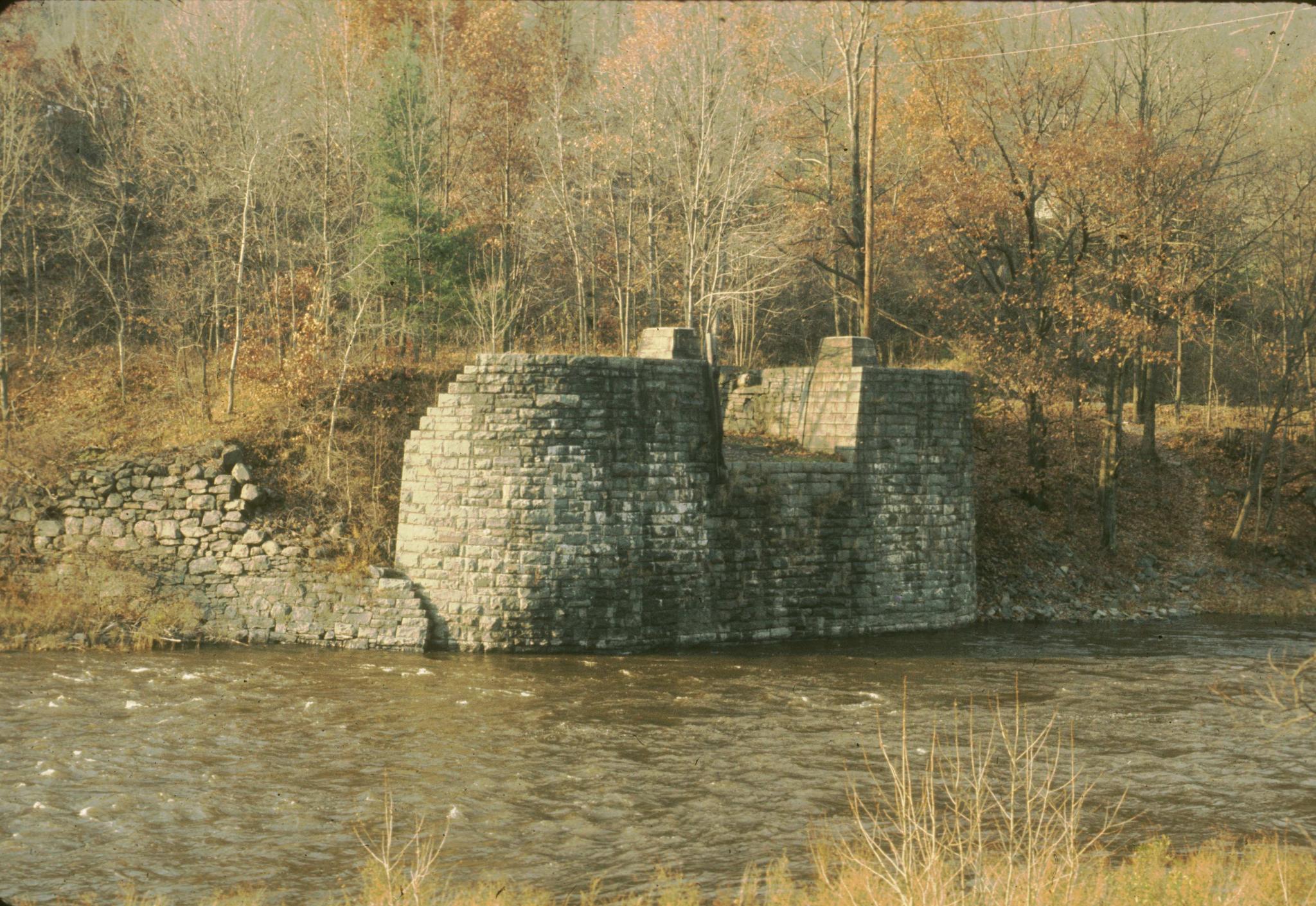 Photograph of the west abutment of the Lackawaxen Aqueduct.  The aqueduct is…