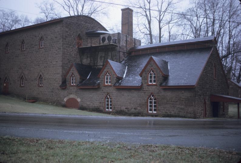 View of furnace with enclosed charging deck and casting house