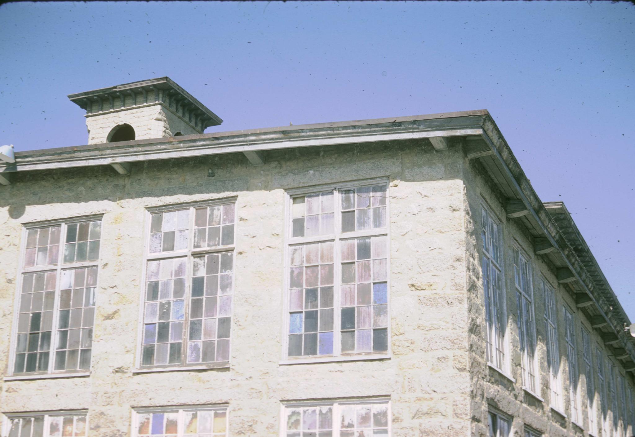 Photograph of the top story and roof-line of the mill.