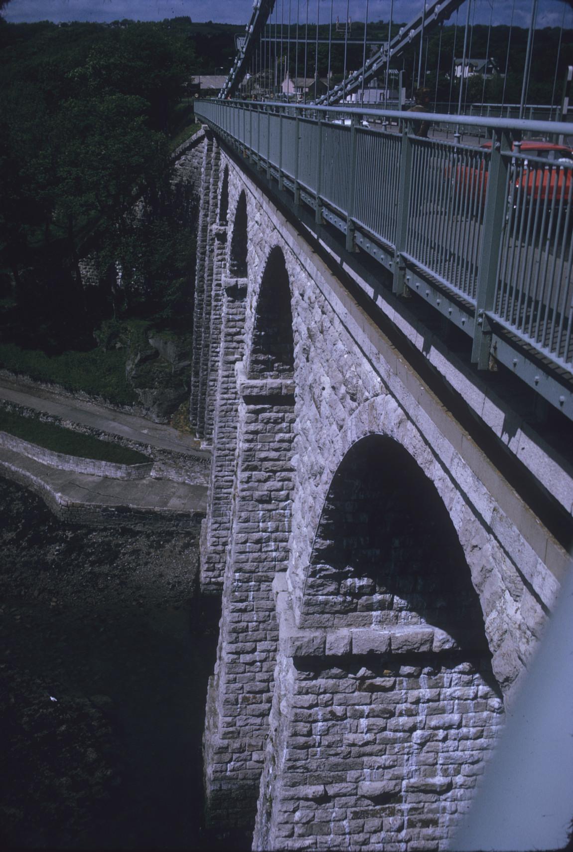 View down from deck level at tower to waterway, shore. 