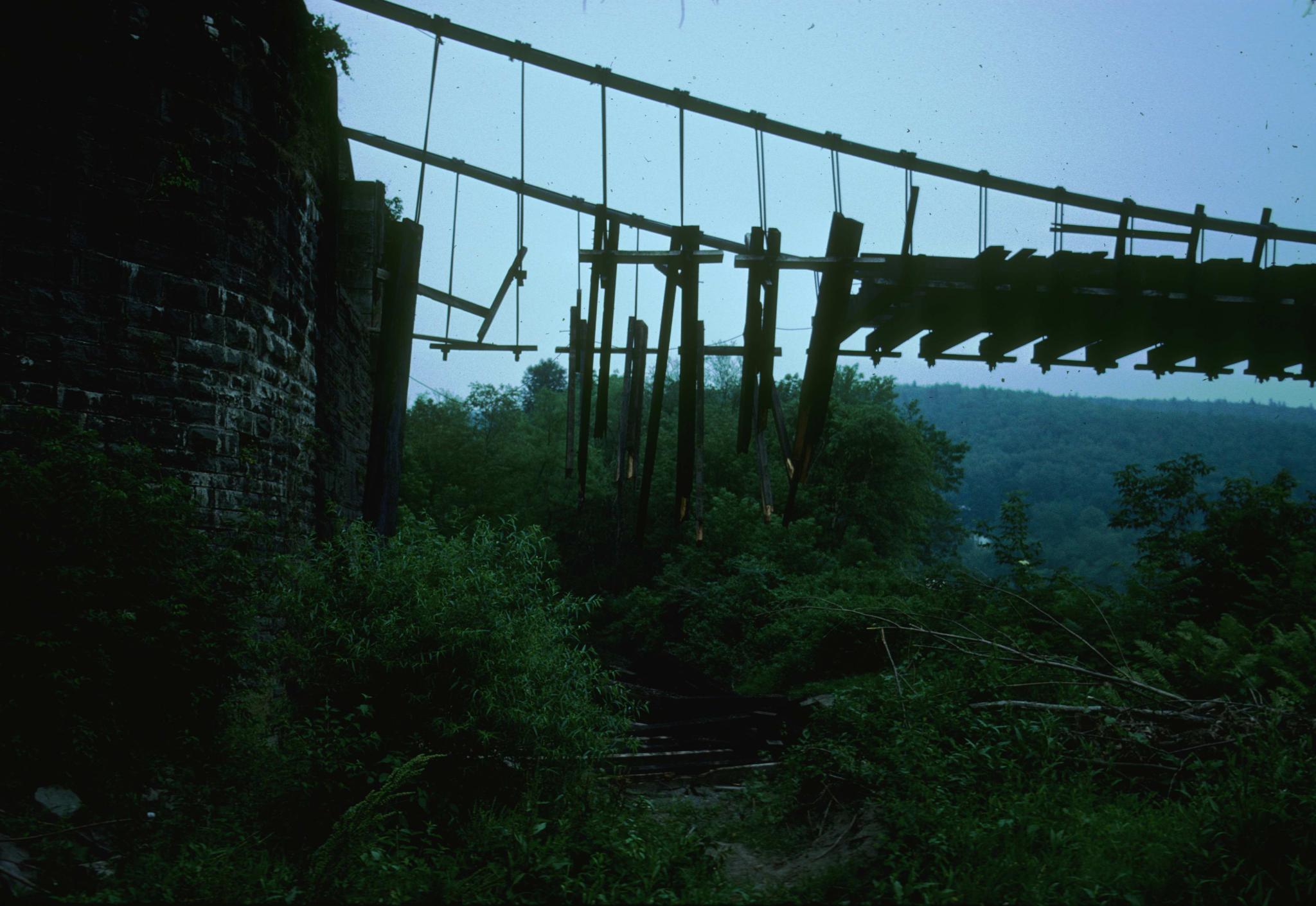 Photograph of damage to the Delaware (Roebling) Aqueduct in June of 1977.  A…