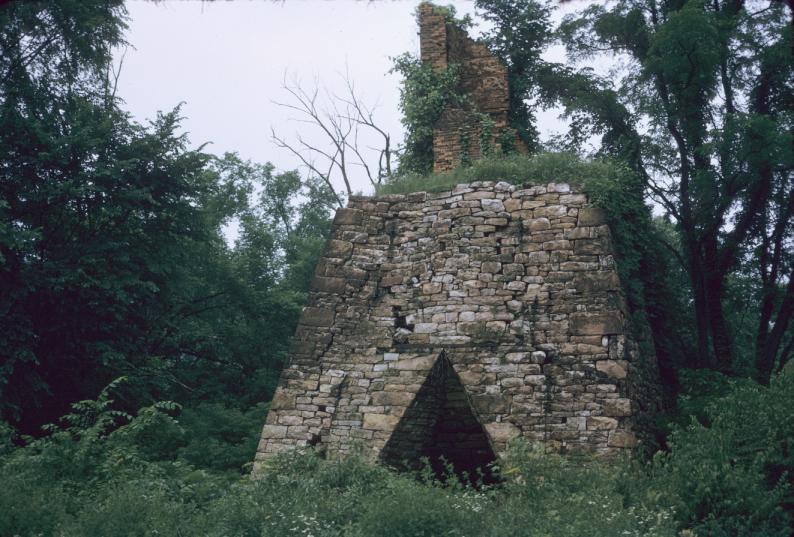 View of remains of stone iron furnace with partial brick stack (deteriorated)