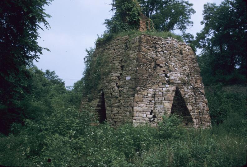 Remnant of stone furnace with brick stack