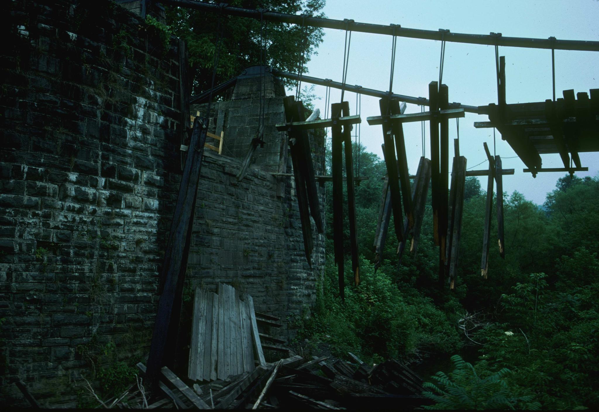 Photograph of damage to the Delaware (Roebling) Aqueduct showing damage to deck…