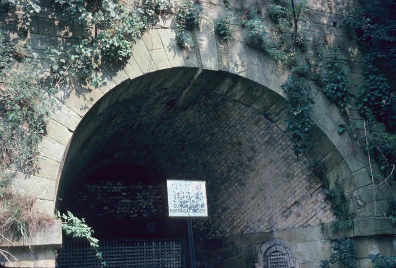 Dry-stack stone archway and brick interior of furnace access