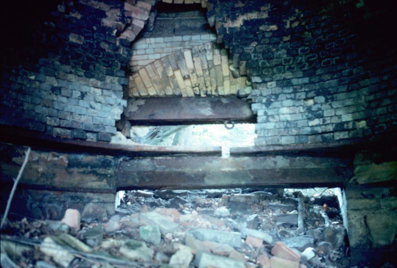 View of deteriorated brickwork on interior of iron furnace