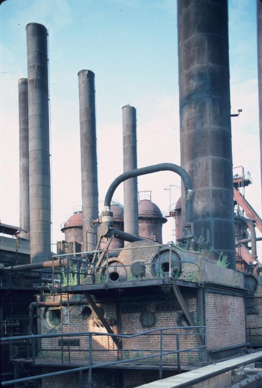 View of boiler structure with stoves, furnace in background