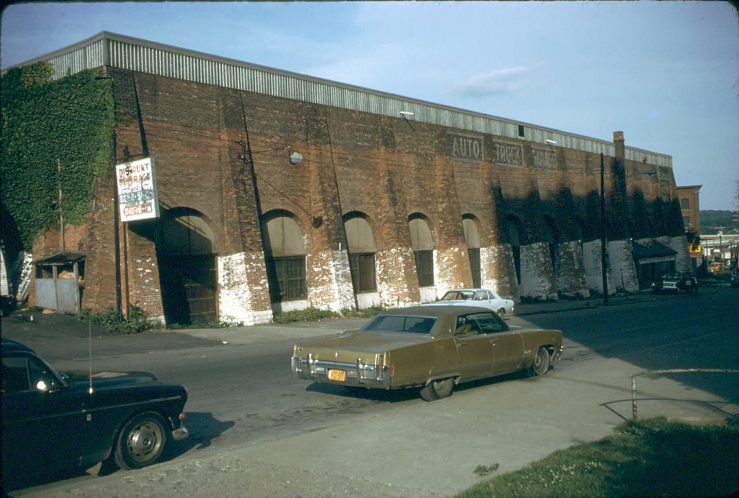 The image shows a written sign on the structure: \"AutoTruck Garages\…