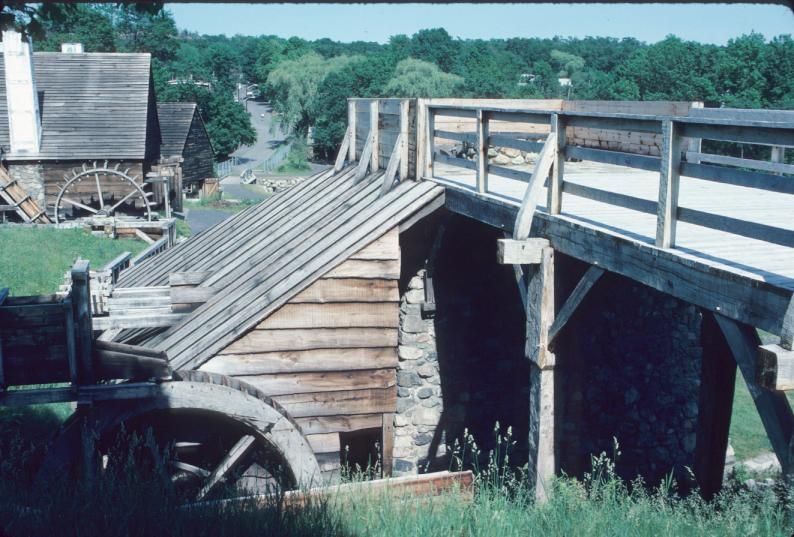 View of furnace, charging deck and overshot water wheel; forge and undershot…