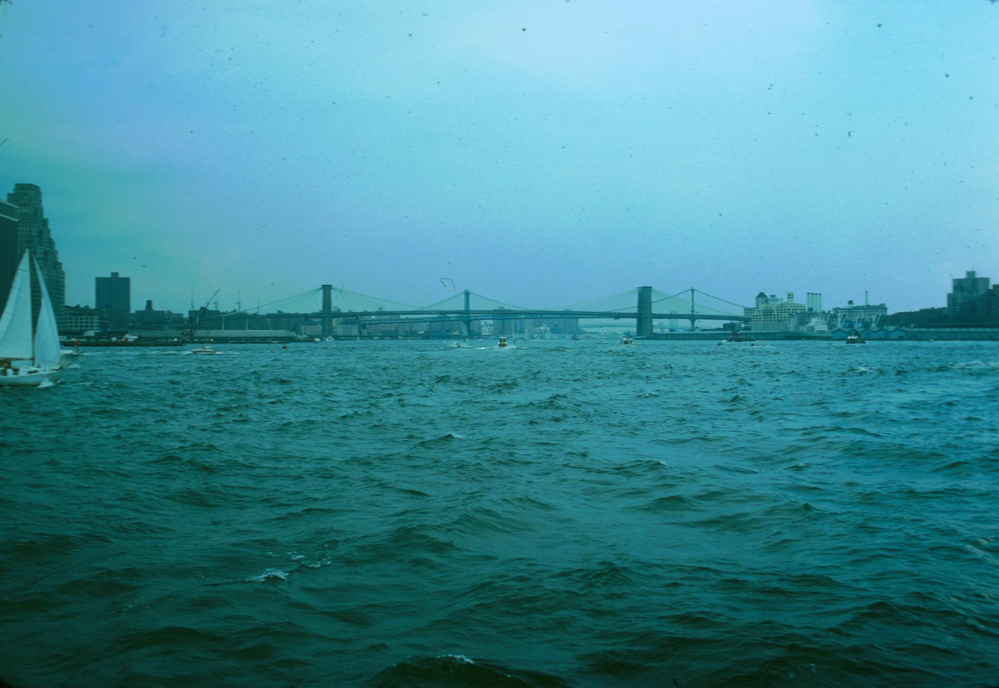 Photograph of Brooklyn Bridge taken from the harbor.