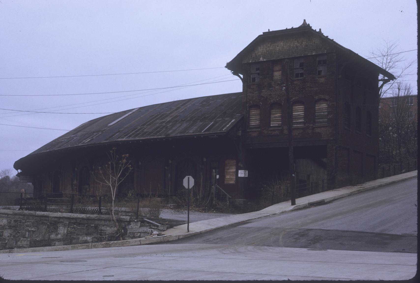 General view; rounded structure with upper floors on end