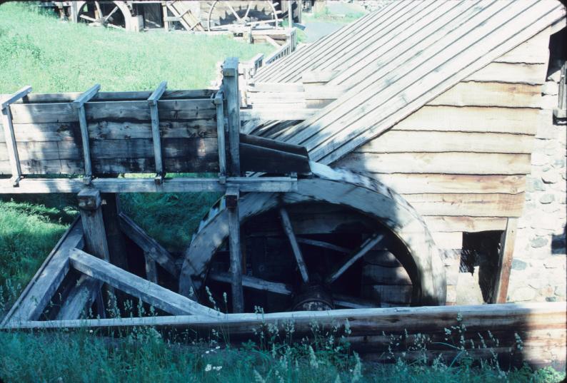 Overshot water wheel in operation at blast furnace; forge water wheels in…