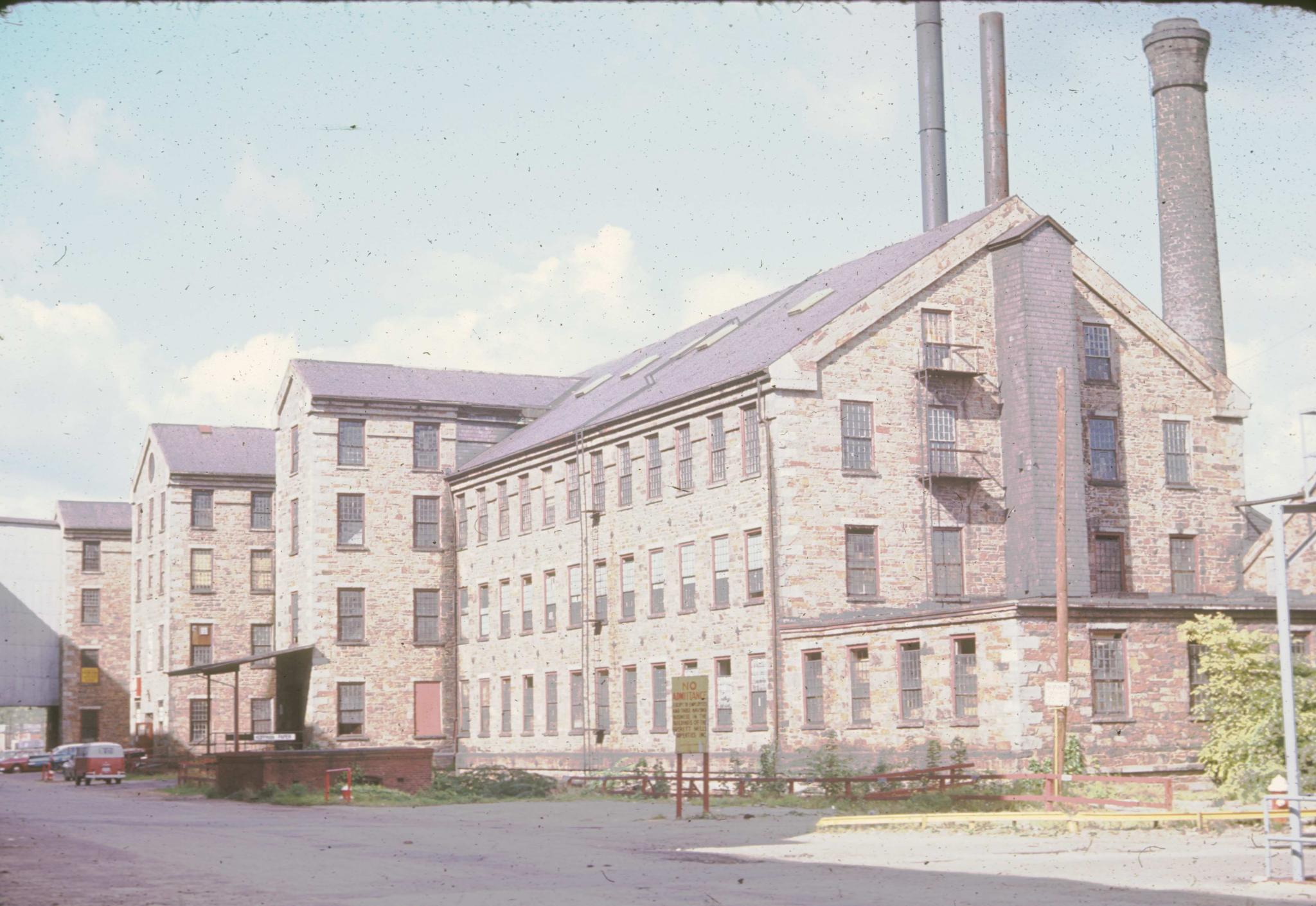 Three-quarters view of an unidentified machine shop in Lawrence, Massachusetts…