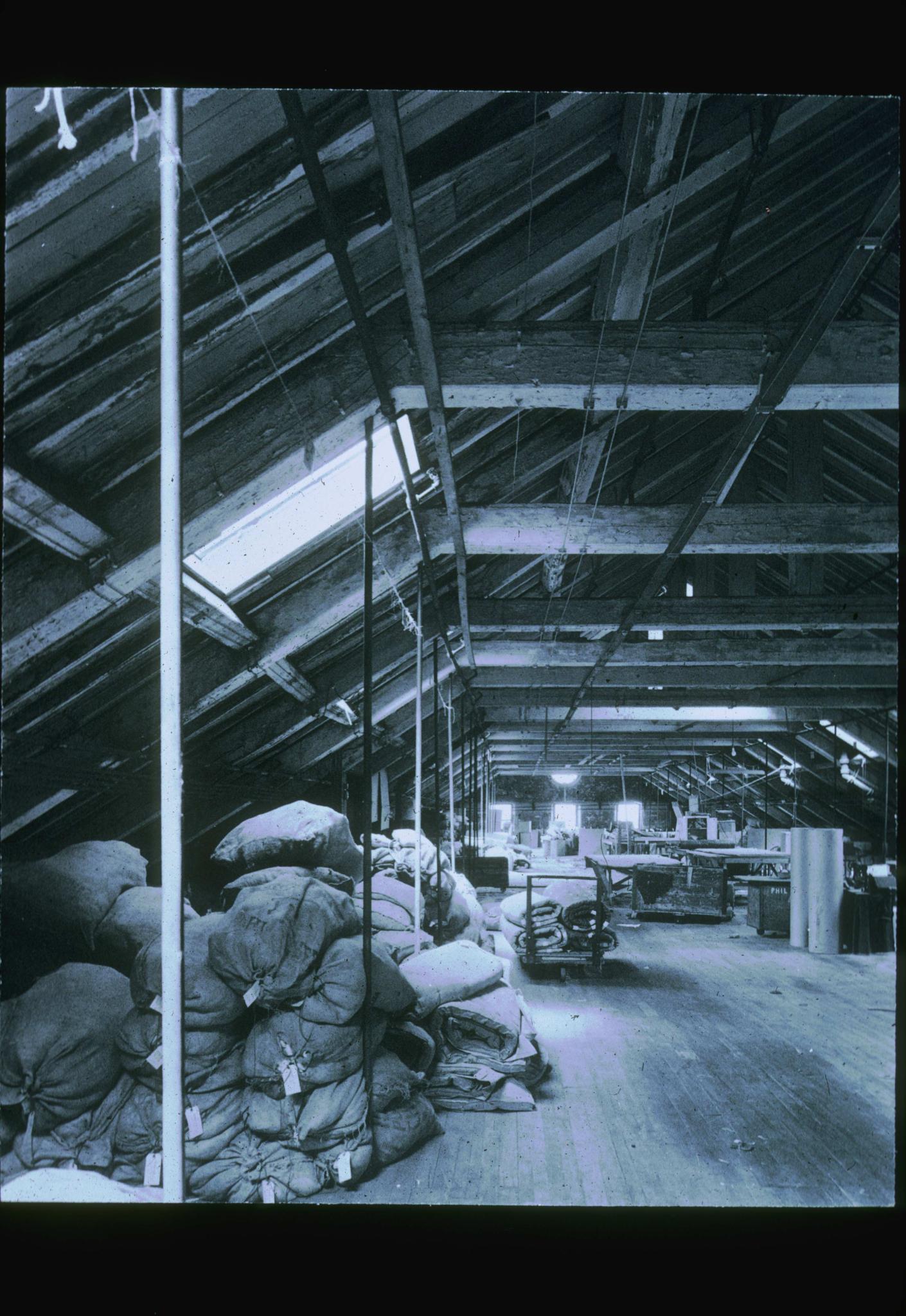 Black and white photograph of the attic of an unidentified 1846 machine shop in…