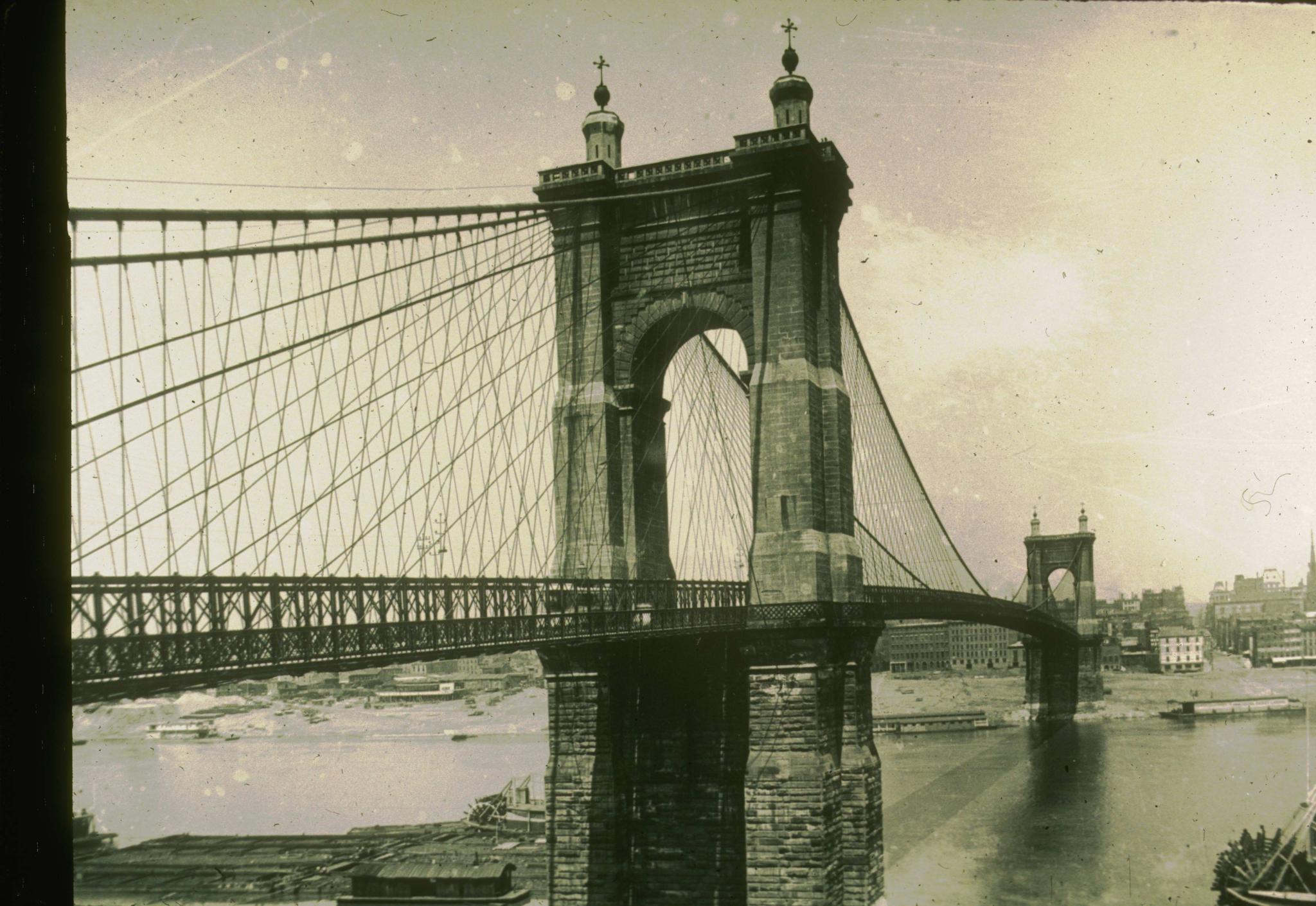 Historic 19th century photograph of the Cincinnati Bridge.  Photograph focuses…