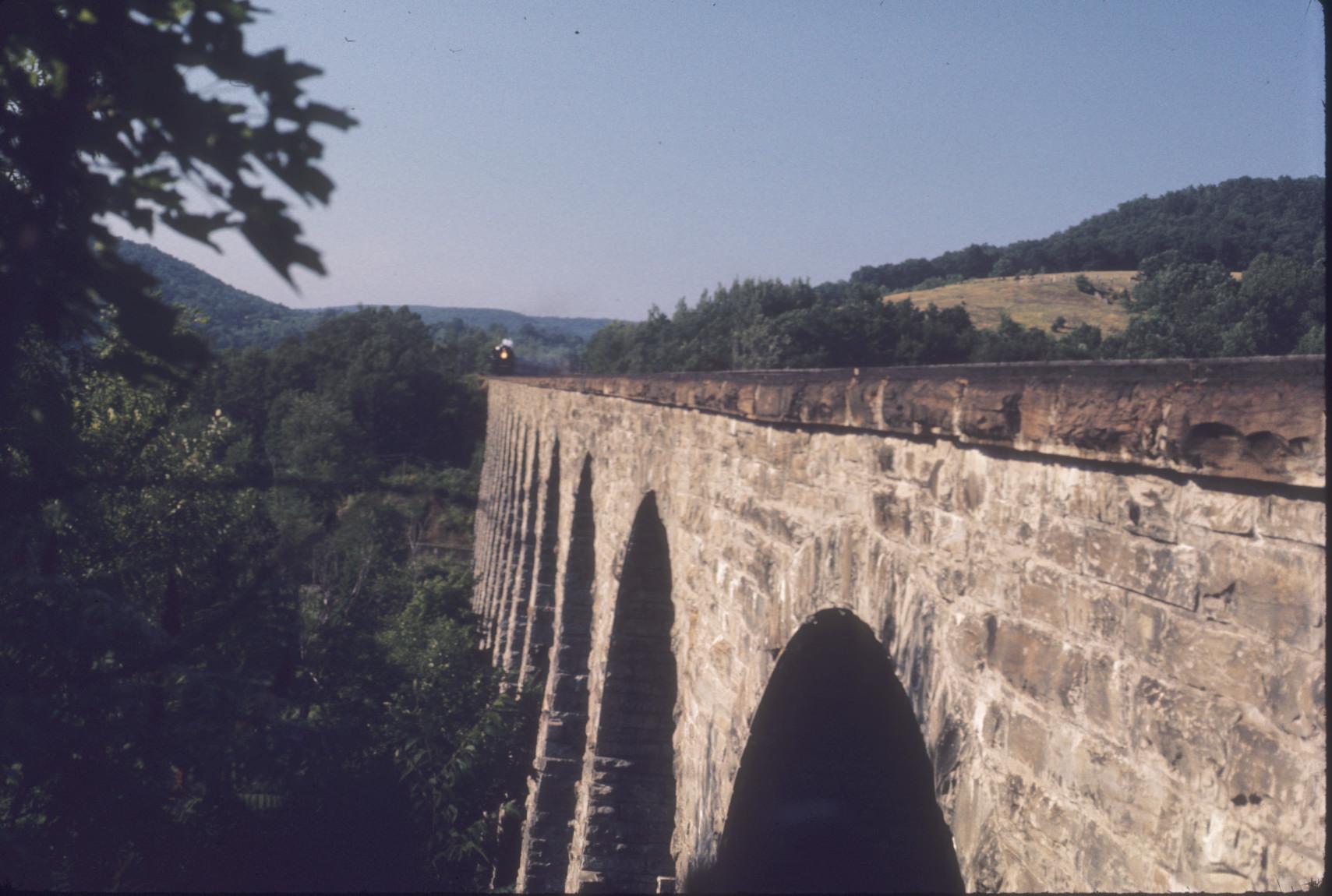 Steam locomotive #759 with excursion train approaching Starrucca Viaduct near…