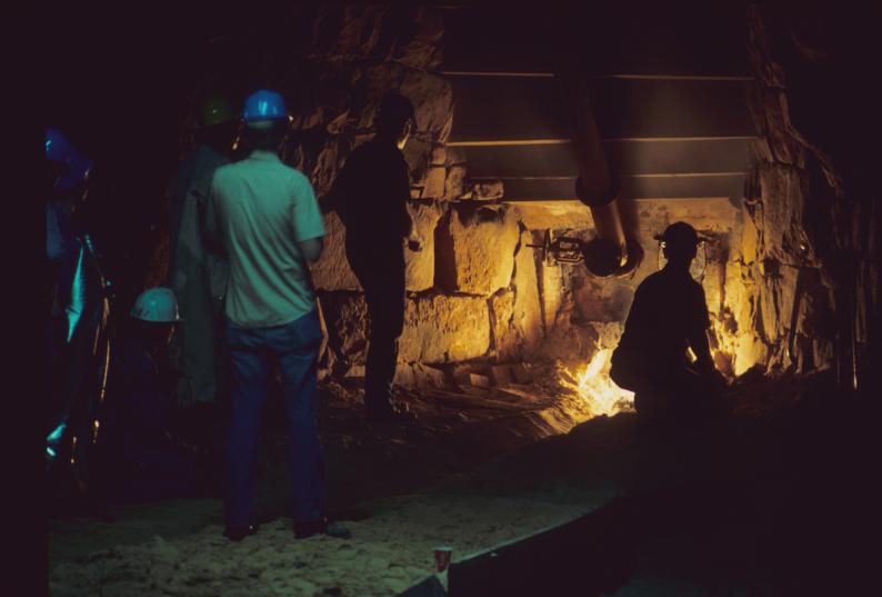 View of unidentified people tapping the first pour of the reconstructed furnace…