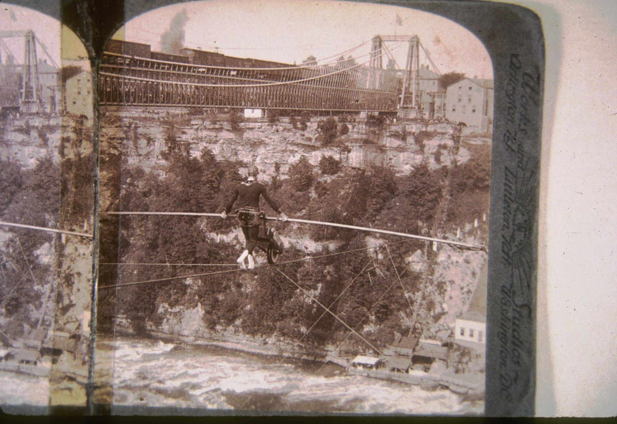 Photograph a tight-rope walker crossing the Niagara gorge.  The Niagara…