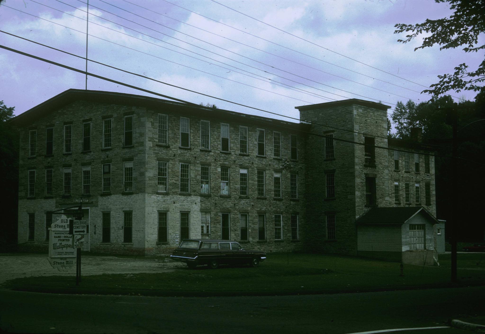 Photograph of an unidentified stone mill in Adams, Massachusetts.  Sign out…