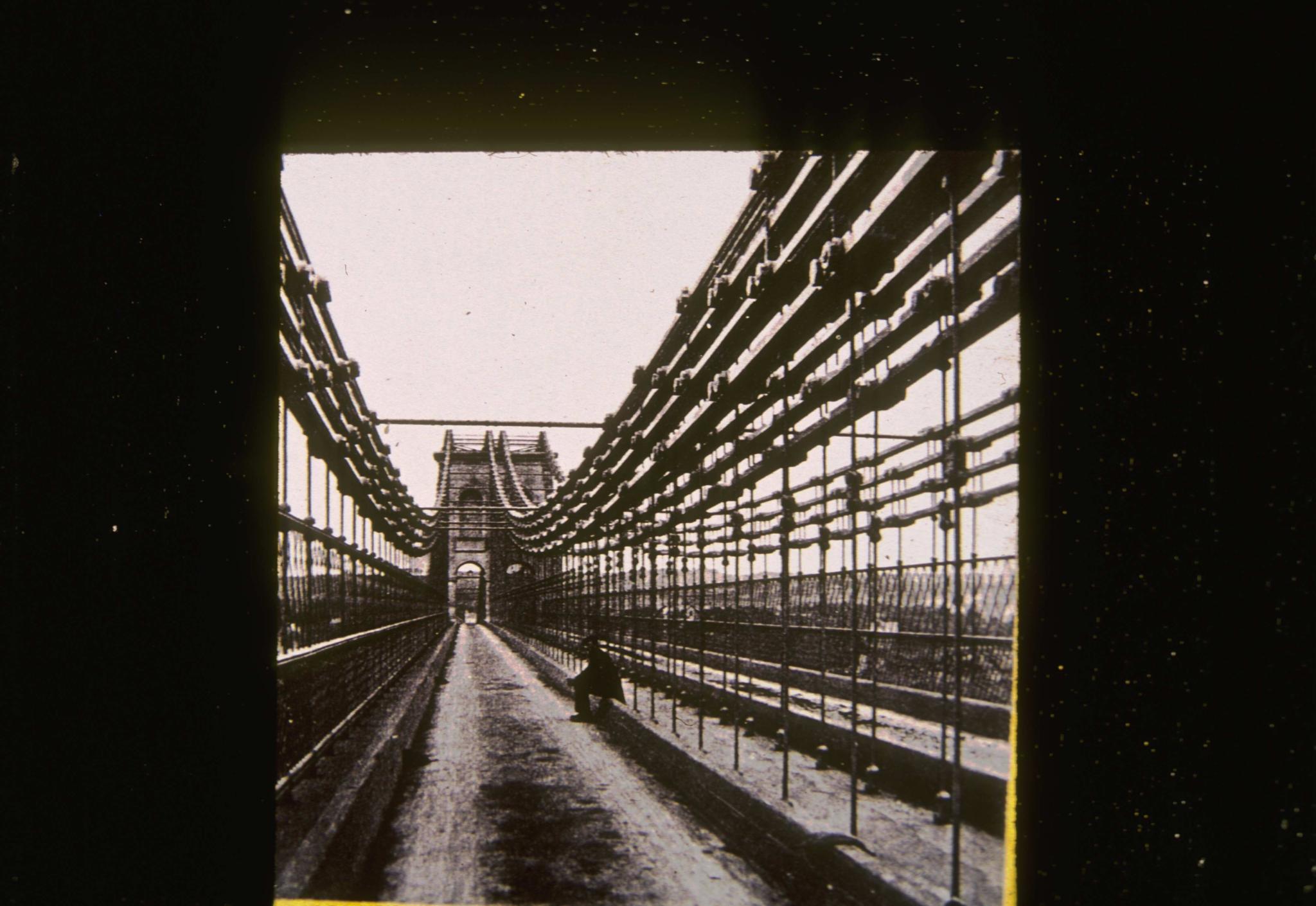 Historic photograph of the Menai Straight bridge looking along the deck.  An…