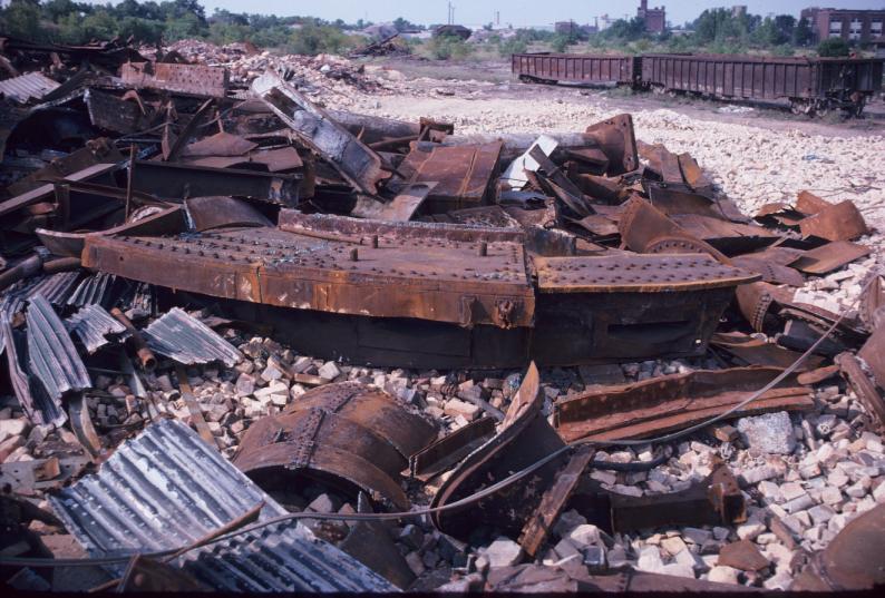 View of scrap metal and railcars during blast furnace demolition.