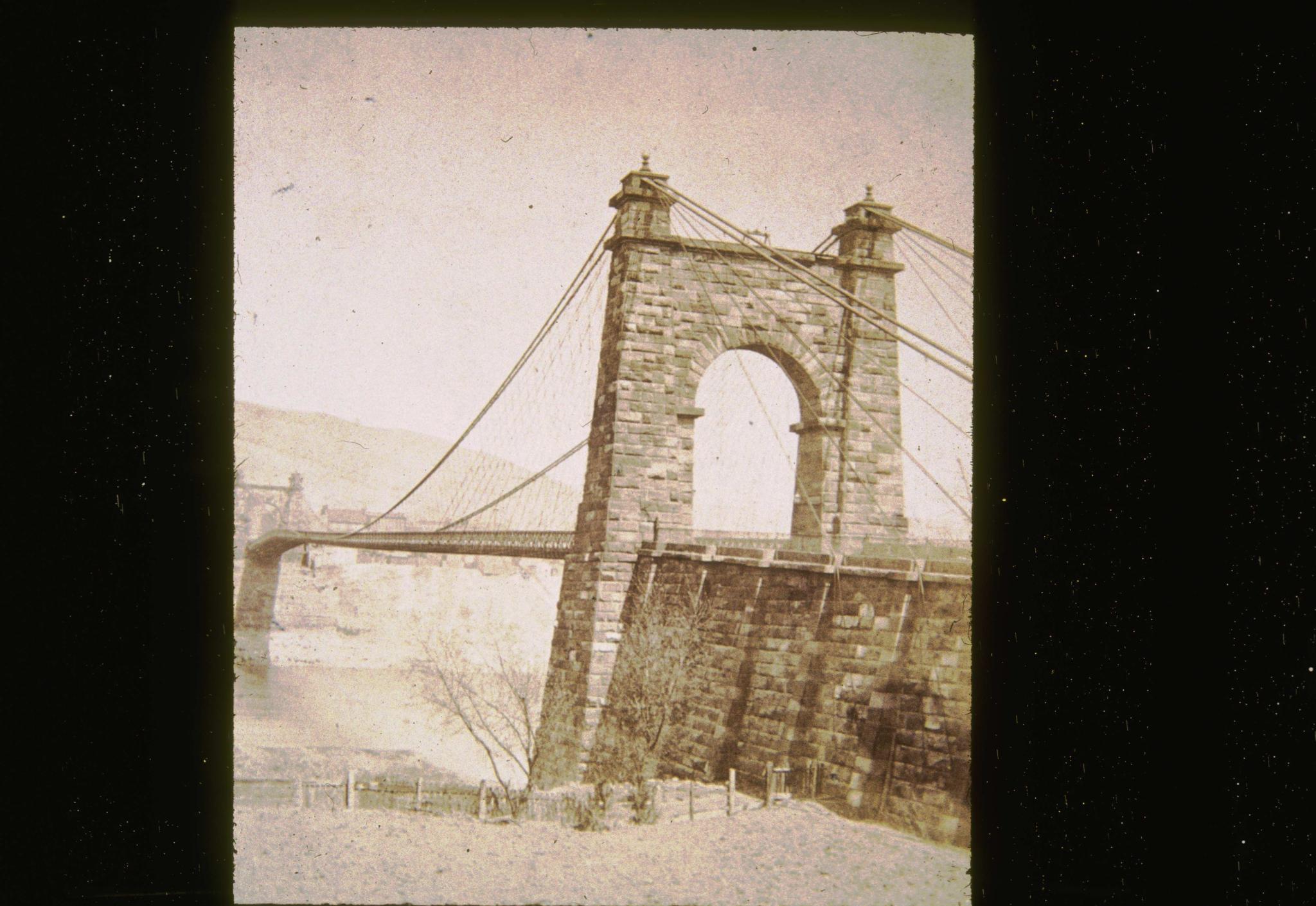 Historic photograph of the Wheeling Bridge emphasizing the anchorage and tower.