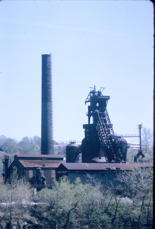 View of blast furnace, smoke stack, and other structures.