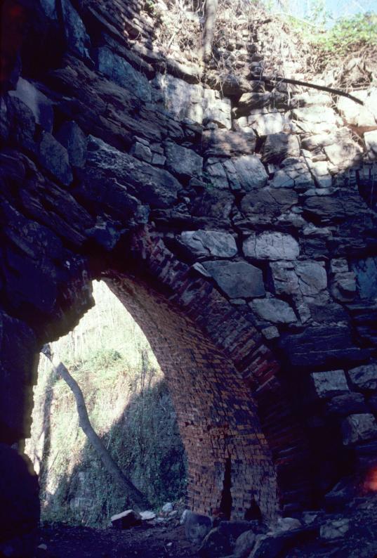 View of masonry blast furnace interior and brick arch.