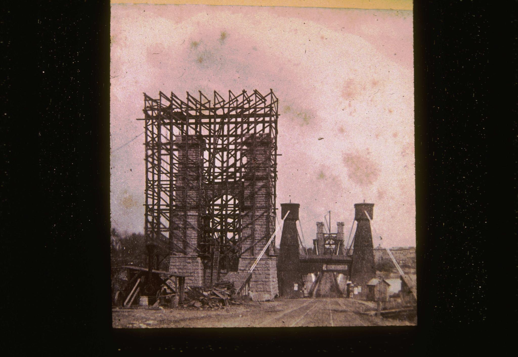 Historic photograph showing the original Hennepin Avenue Bridge (on right) and…