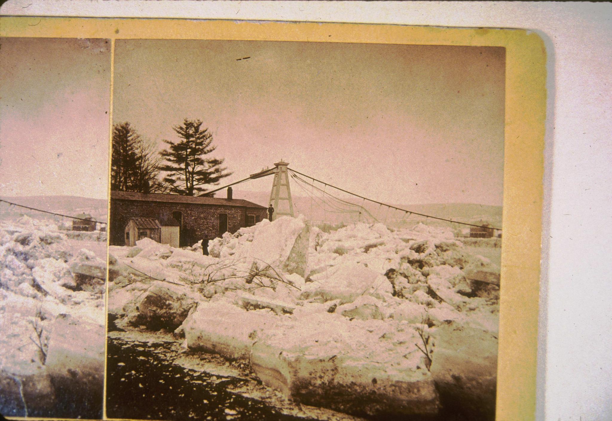 Historic photograph of the (second) Port Jervis Suspension Bridge with a large…