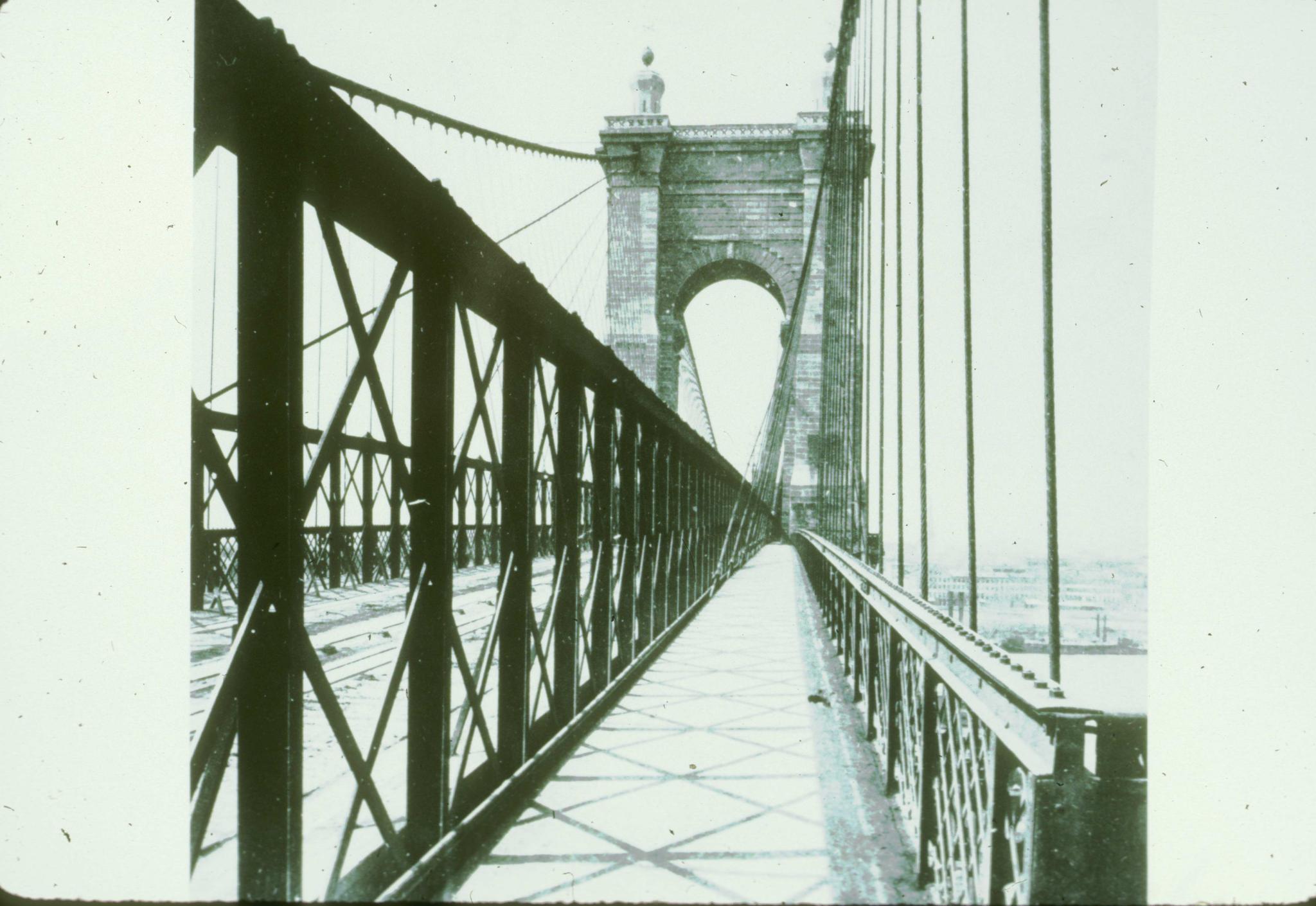 Historic photograph of an unidentified suspension bridge.  The photograph was…